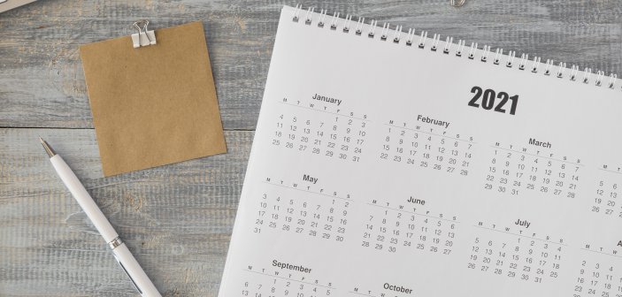 a calendar with a pen on a table