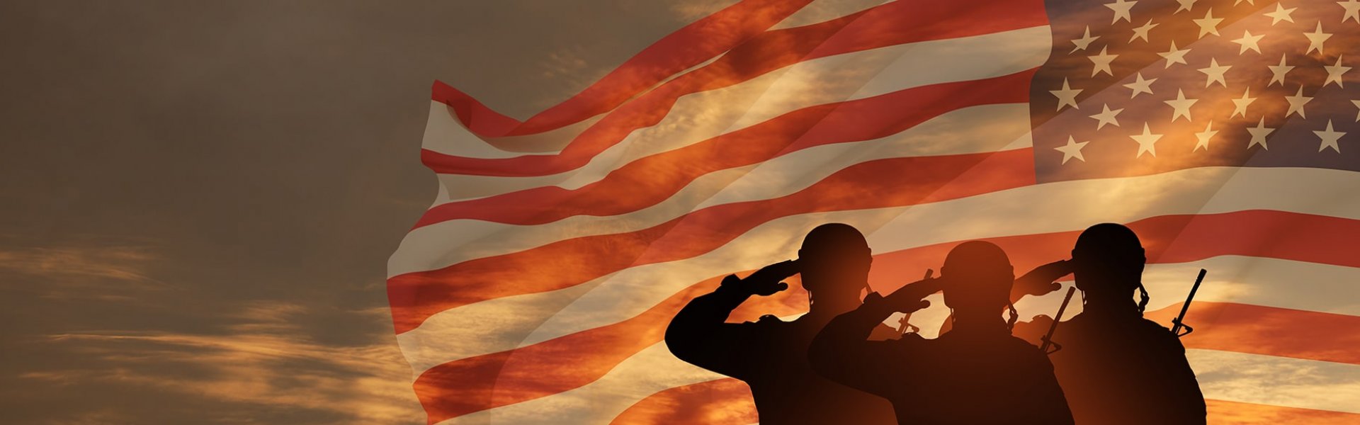 Soldiers saluting in front of American flag