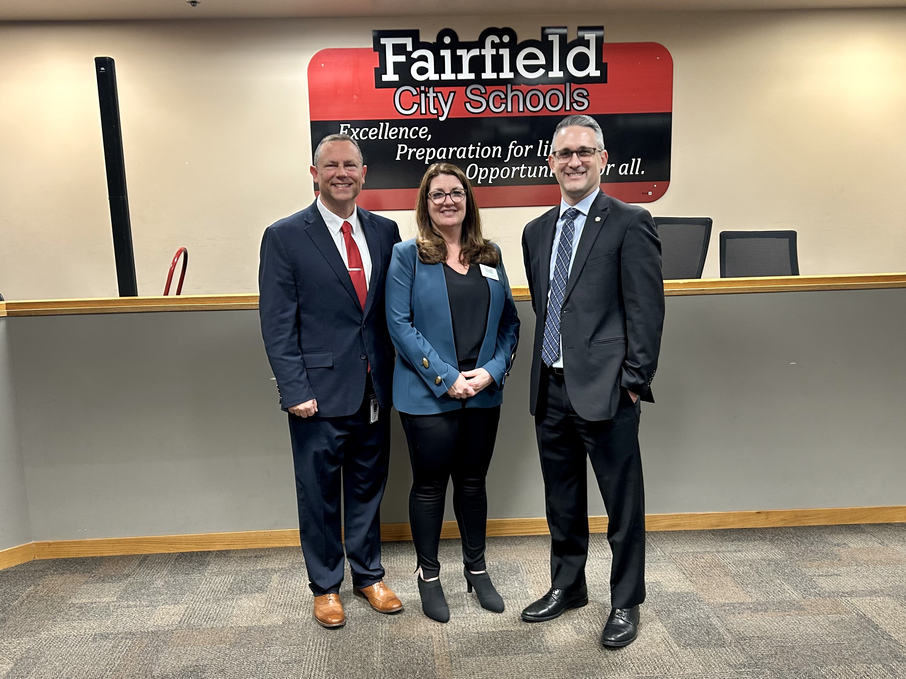 Three people smiling in office